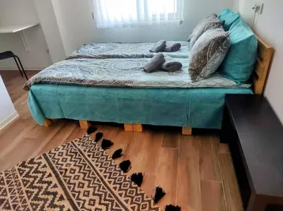 a bed with pillows on it in a room at Le Petit Studio in Kanarevo Brdo
