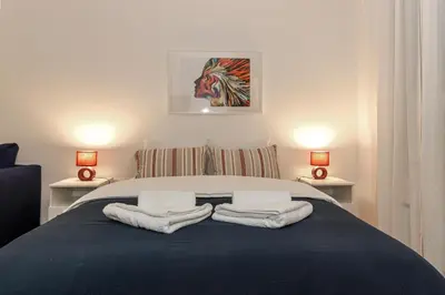 a bedroom with a bed with towels on it at Fortuna - cozy studio to relax Novi Beograd, parking 5 eur per day in Belgrade