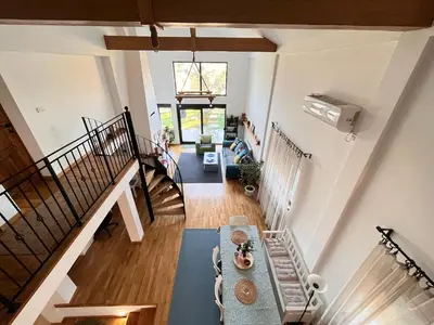 a living room with a staircase and a table at Vila blizu Beograda - My Family Cottage in Ba°evac