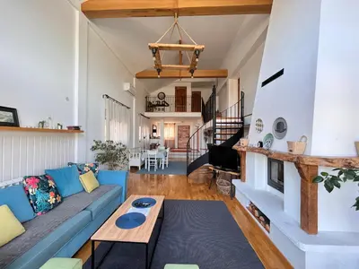 a living room with a blue couch and a fireplace at Vila blizu Beograda - My Family Cottage in Ba°evac