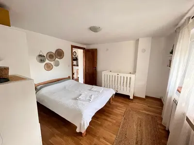a bedroom with a white bed in a room at Vila blizu Beograda - My Family Cottage in Ba°evac