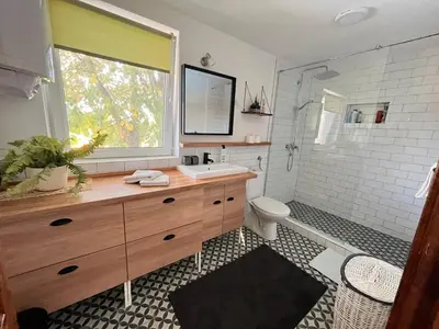 a bathroom with a sink and a toilet and a window at Vila blizu Beograda - My Family Cottage in Ba°evac