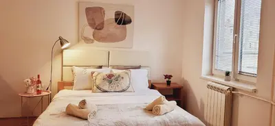 a bedroom with a bed with two pillows on it at Bulevar Plus in Belgrade