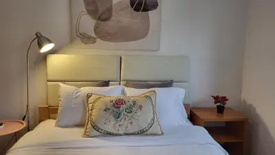 a bedroom with a bed with a pillow on it at Bulevar Plus in Belgrade