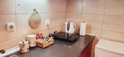 a counter with a coffee maker and a basket on it at Bulevar Plus in Belgrade