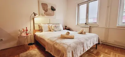 a bedroom with a bed with two stuffed animals on it at Bulevar Plus in Belgrade