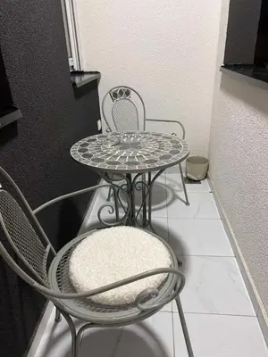 a table and two chairs and a table and a table at Apartman Alexandra in Ruma