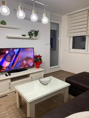 a living room with a large flat screen tv at Apartman Alexandra in Ruma