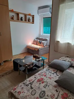 a living room with two beds and a couch at Apartman Mirka 2 in Karaburma