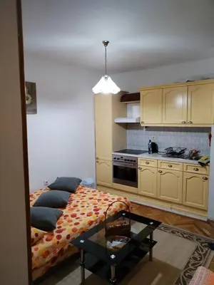 a living room with a couch and a kitchen at Apartman Mirka 2 in Karaburma