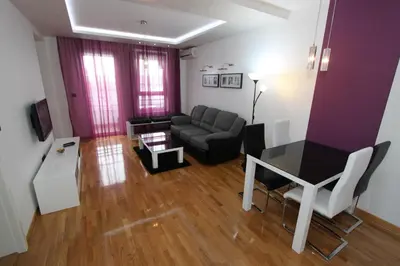 a living room with a couch and a table at Aleksandar - Stan Na dan Belvil Novi Beograd in Belgrade