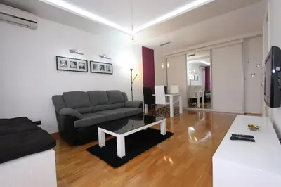 a living room with a couch and a table at Aleksandar - Stan Na dan Belvil Novi Beograd in Belgrade