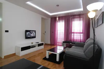 a living room with a couch and a table at Aleksandar - Stan Na dan Belvil Novi Beograd in Belgrade