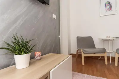 a living room with a table and a chair at Portago - Stan na dan Belvil Novi Beograd in Belgrade