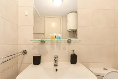 a white bathroom with a sink and a toilet at Portago - Stan na dan Belvil Novi Beograd in Belgrade