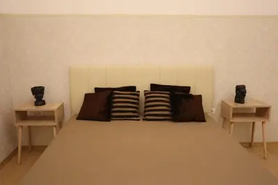a bedroom with a bed with two night stands at Golden Velvet apartment Belgrade in Belgrade