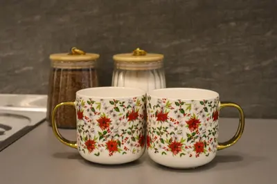 two coffee mugs are sitting on a table at Golden Velvet apartment Belgrade in Belgrade