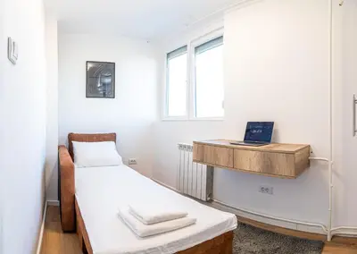 a small room with two beds and a window at Sunny Nest Apartment in Fontana
