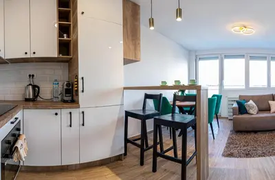 a kitchen and living room with a table and chairs at Sunny Nest Apartment in Fontana