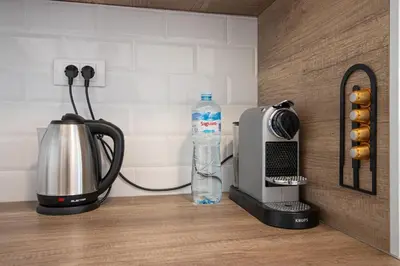 a bottle of water next to a toaster and a bottle of water at Sunny Nest Apartment in Fontana