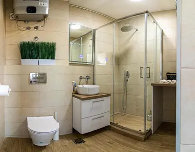 a bathroom with a shower and a toilet and a sink at Sunny Nest Apartment in Fontana