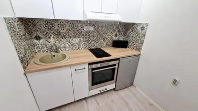 a small kitchen with a sink and a counter top at Zeus in Zemun