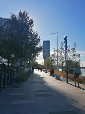 people walking down a sidewalk in a city at Belgrade Waterfront Cozy Symphony 1 in Sajmište