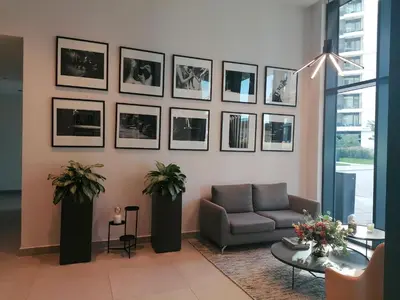 a living room with a couch and pictures on the wall at Belgrade Waterfront Cozy Symphony 1 in Sajmište