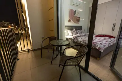 a small room with a bed and a table and chairs at Belgrade Waterfront Cozy Symphony 1 in Sajmište