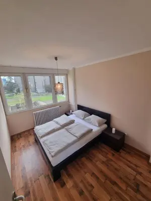 a bedroom with a large bed and two windows at Hawaii- 2 bdr, Arena, Sava centar, FREE PARKING in Novi Beograd