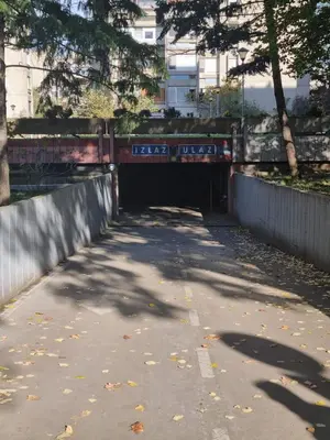 a tunnel in a park with trees and a sidewalk at Hawaii- 2 bdr, Arena, Sava centar, FREE PARKING in Novi Beograd