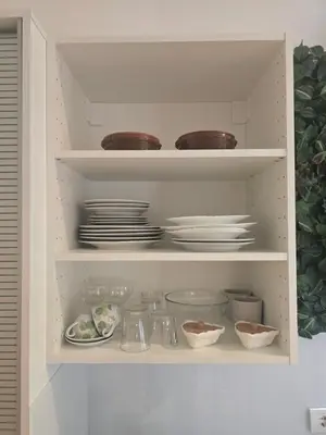 a cabinet filled with plates and bowls and dishes at Apartman Stepa K3 in Belgrade
