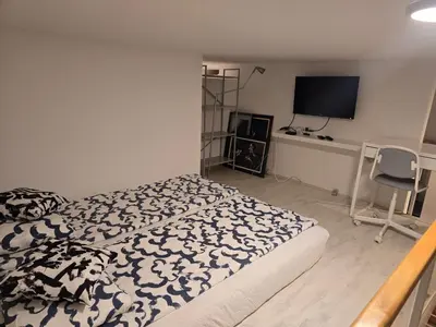 a bedroom with a bed with a black and white blanket at Apartman Stepa K3 in Belgrade