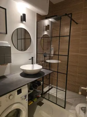 a bathroom with a sink and a washing machine at Apartman Stepa K3 in Belgrade