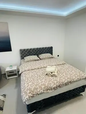a bedroom with a large bed with a large bedspread at Luxury Centar 2 in Arandjelovac