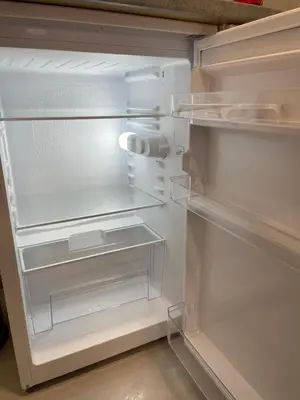 an empty refrigerator with its door open in a kitchen at Luxury Centar 2 in Arandjelovac