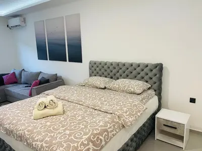 a bedroom with a bed and a couch at Luxury Centar 2 in Arandjelovac