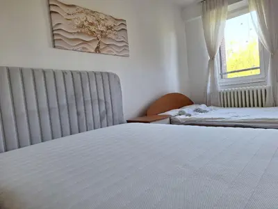 a bedroom with two beds and a window at RIVIJERA GREEN in Belgrade