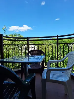 a patio with two chairs and a table and chairs at RIVIJERA GREEN in Belgrade