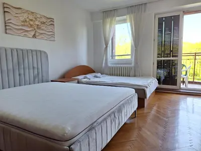 a bedroom with two beds and a window at RIVIJERA GREEN in Belgrade