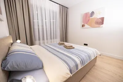 a bedroom with a bed with two towels on it at Belgrade Waterfront Cozy Symphony 2 in Sajmište