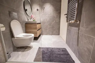 a bathroom with a toilet and a sink and a shower at Belgrade Waterfront Cozy Symphony 2 in Sajmište