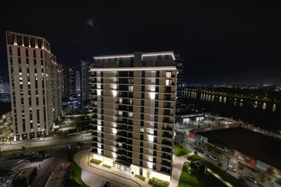 a tall building in a city at night at Belgrade Waterfront Cozy Symphony 2 in Sajmište