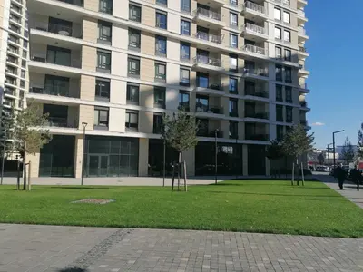 a large apartment building with a park in front of it at Belgrade Waterfront Cozy Symphony 2 in Sajmište