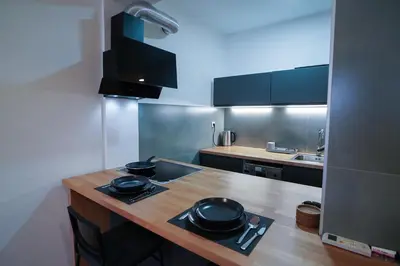 a kitchen with a wooden counter with pots and pans on it at Apartment Grau in Žarkovo