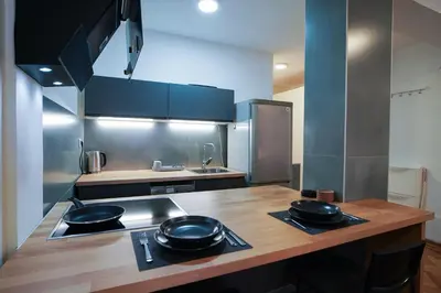 a kitchen with two frying pans on top of a counter at Apartment Grau in Žarkovo