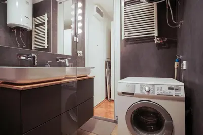 a bathroom with a washing machine and a sink at Apartment Grau in Žarkovo