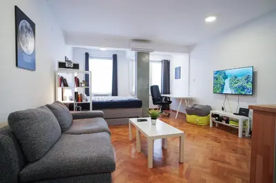 a living room with a couch and a table at Apartment Grau in Žarkovo