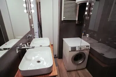 a bathroom with a washing machine and a sink at Apartment Grau in Žarkovo