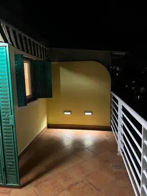 a room with a balcony with green shutters at Silicon Valley studio in Belgrade
